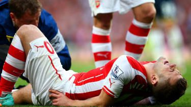 Jack Wilshere de la Arsenal primește tratament în timpul meciului din Barclays Premier League dintre Arsenal și Tottenham Hotspur
