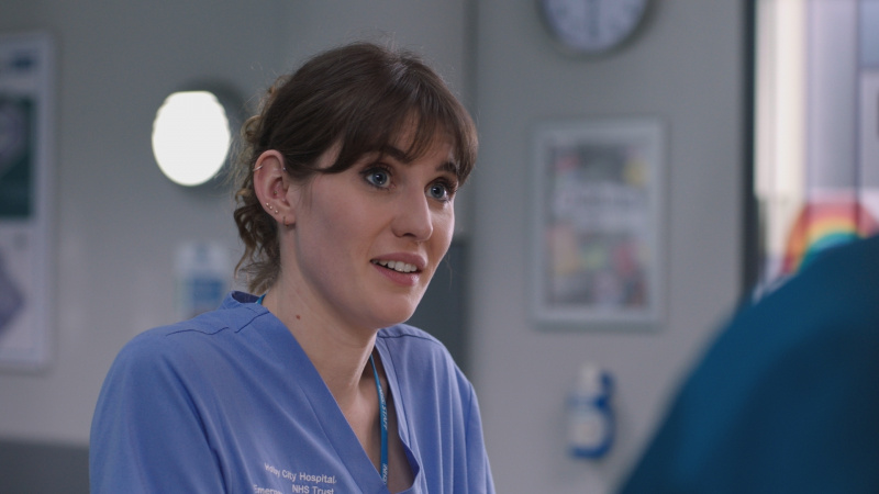  โจดี้'s face lights up when Dylan offers his professional support during a tough shift at Holby ED.