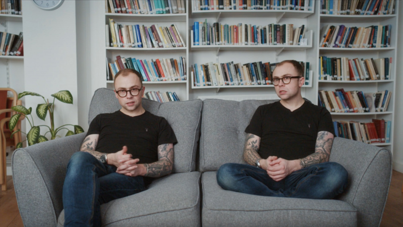   Sunt doi Joe's sitting next to each other on the sofa. One is Mick, who is the voice in Joe's head.