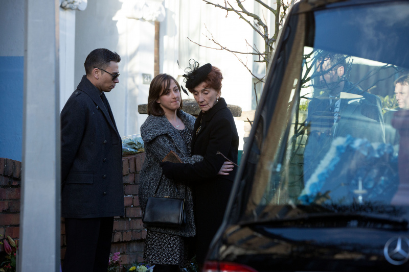  Sonia Fowler utešuje Dot Cotton pred pohrebným vozom, zatiaľ čo Fatboy sleduje