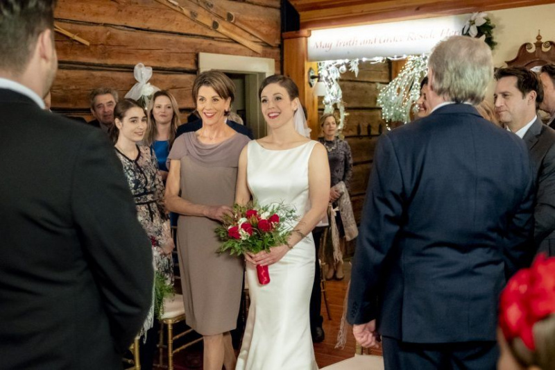When Miranda Chester set off to find information on her biological father two Christmases ago, she never imagined that her investigation would lead her to both the family she had always longed for and Ian McAndrick the love of her life. After her romantic engagement last Christmas, Miranda prepares to marry Ian surrounded by his family, and her new family, the Whitcombs. Her plans are quickly complicated when a mysterious visitor who claims to have ties to her late parents reaches out to her just days before her wedding. While Miranda navigates this new relationship, her late fathers widow, Margaret, forges a surprising romance with a friend from the past. Photo: Wendie Malick, Erin Krakow Credit: 2018 Crown Media United States LLC/Photographer: Kailey Schwerman