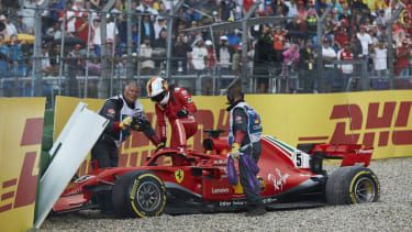 Sebastian Vettel klatrer fra sin Ferrari efter at have styrtet ud af 2018 F1 German Grand Prix