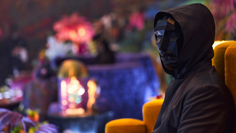 Blekksprutspill sesong 3 -karakter iført en svart maske som dekker hele ansiktet og en svart jumpsuit med hette.