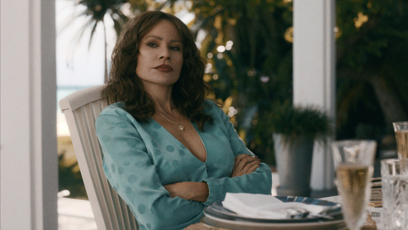   Sofía Vergara as Griselda in a teal dress in Griselda